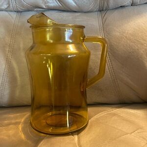 Vintage amber glass pitcher with ice lip.